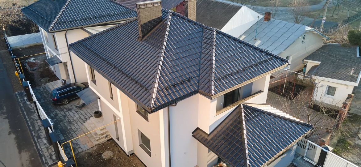 Aerial view of private house with ceramic shingles covered roof top. Investment in real estate concept